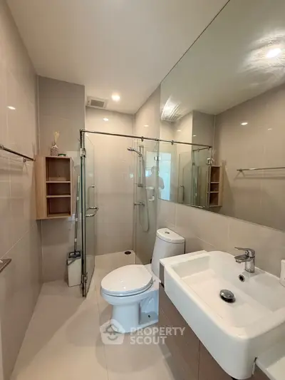 Modern bathroom with glass shower and sleek fixtures