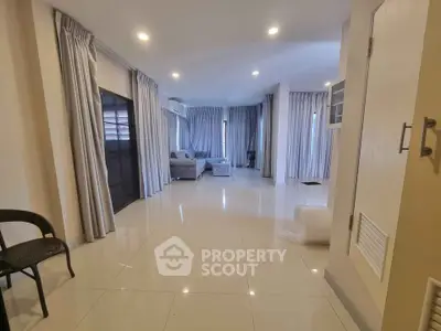 Spacious living room with modern decor and large windows for natural light.