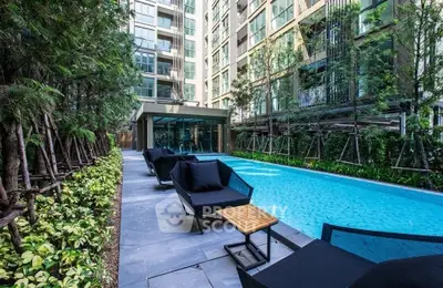 Luxurious apartment complex with modern pool and lush greenery, perfect for relaxation and leisure.