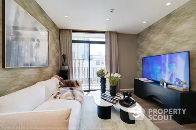 Luxurious modern living room with plush sofa, sleek entertainment unit, and floor-to-ceiling windows leading to a sunlit balcony.