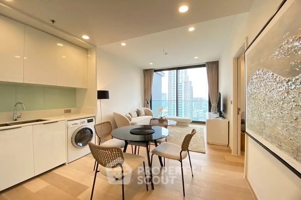 Modern open-plan living room with kitchen, dining area, and city view in luxury apartment.