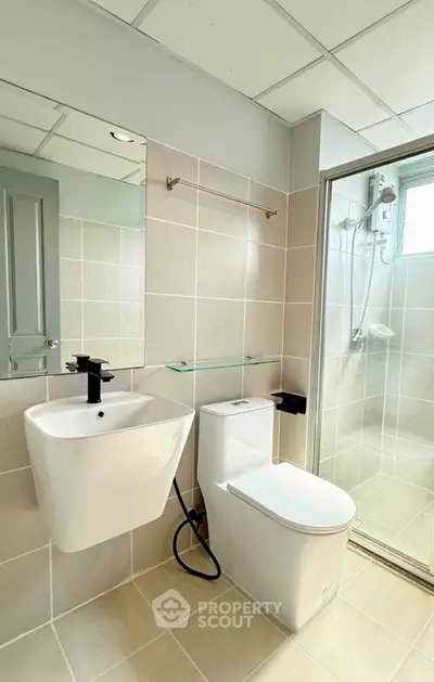 Modern bathroom with sleek fixtures and glass shower enclosure