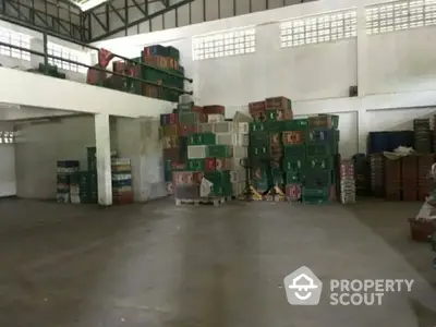 Spacious warehouse interior with stacked crates and high ceilings