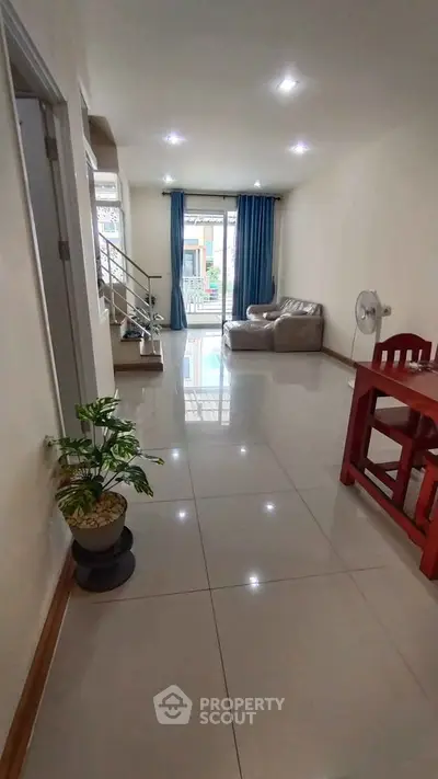 Spacious living room with modern decor and large windows for natural light.