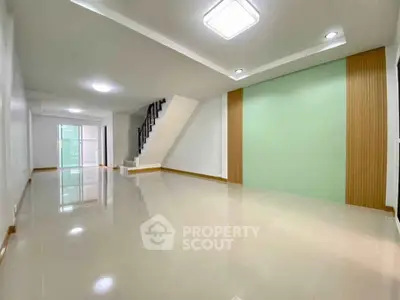 Spacious modern living room with staircase and stylish ceiling lights