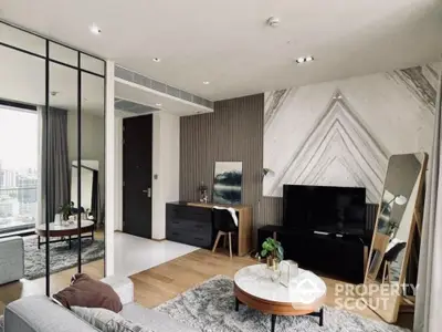 Modern living room with stylish decor and city view, featuring a large mirror and cozy seating area.