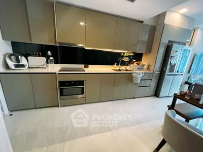 Modern kitchen with sleek cabinetry and built-in appliances in a stylish apartment.