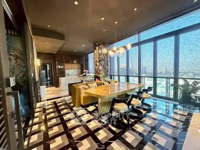 Luxurious open-plan kitchen with marble floors and panoramic city views