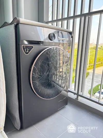 Modern washing machine on a balcony with scenic view, perfect for urban living convenience.