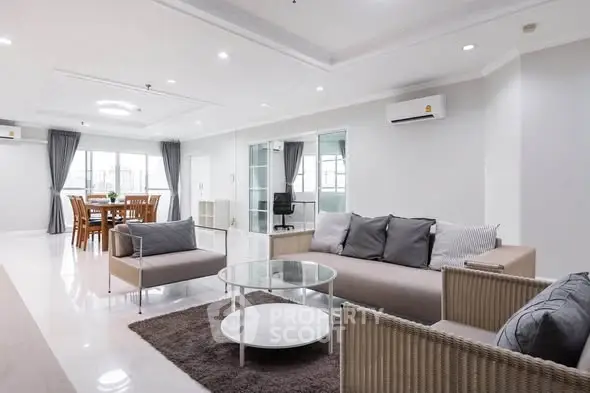 Spacious modern living room with elegant dining area and stylish furniture.