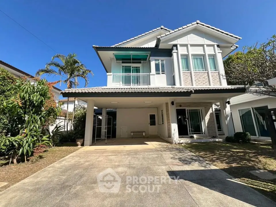 Charming two-story house with spacious driveway and lush garden, perfect for family living in a serene neighborhood.
