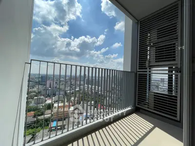 Stunning city view from a modern high-rise balcony with sleek railing design.
