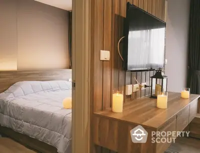 Cozy bedroom with modern wooden decor and mounted TV, perfect for relaxation.