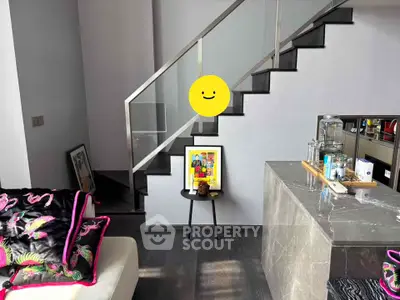 Modern living room with stylish staircase and contemporary decor