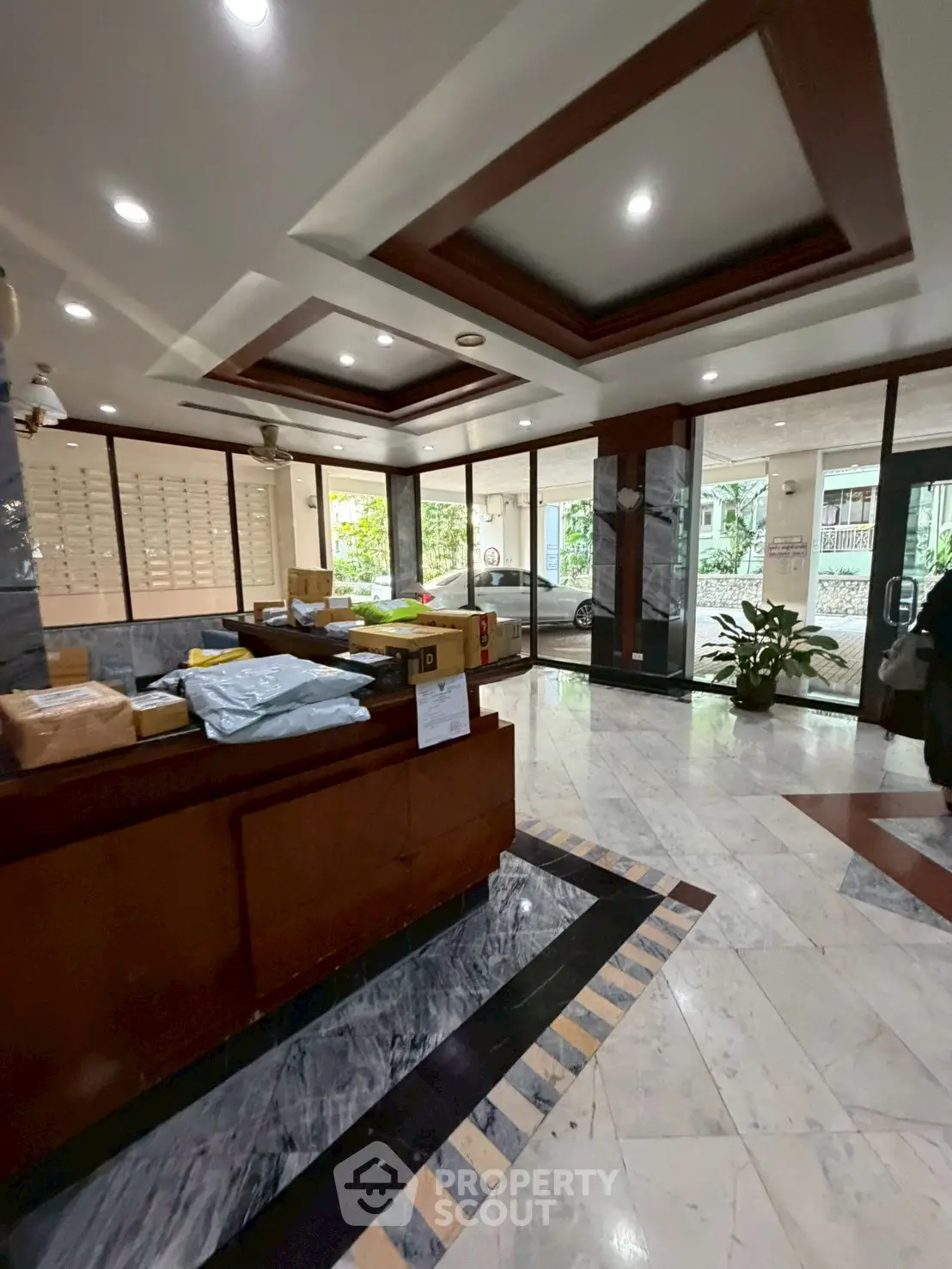 Elegant building entrance with marble flooring and modern design.