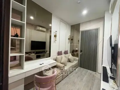 Modern living room with stylish decor and cozy seating in a compact apartment.