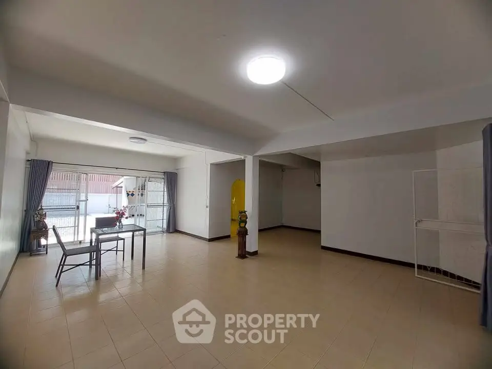 Spacious open-plan living area with natural light and minimalist decor.