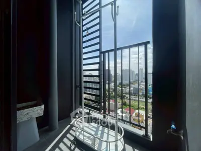 Modern balcony with city view and drying rack in urban apartment