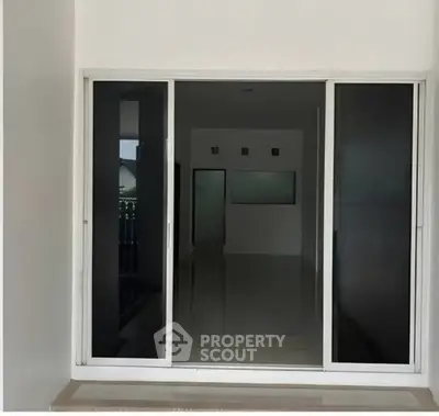 Modern sliding glass doors leading to a spacious interior with sleek design.