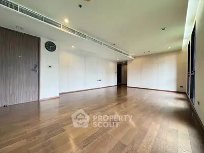 Spacious empty living room with wooden flooring and modern design