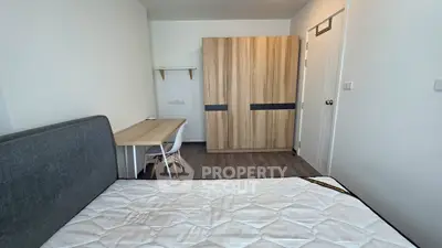 Modern bedroom with wooden wardrobe and study desk, ideal for urban living.
