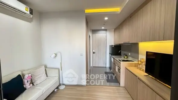Modern apartment interior with cozy living room and sleek kitchen design.