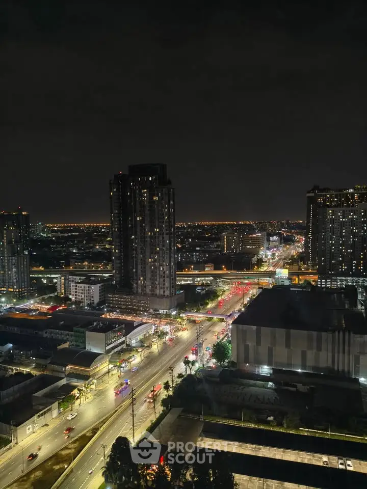 Stunning cityscape view from high-rise building at night with illuminated streets and skyline.