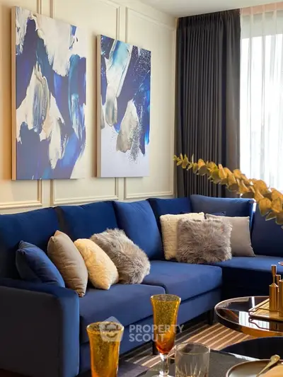Luxurious living room with plush blue sofa and elegant decor, perfect for modern living.