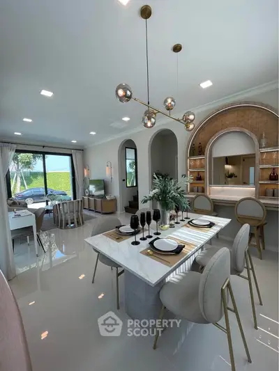Luxurious open-plan living and dining area with modern decor and elegant lighting.