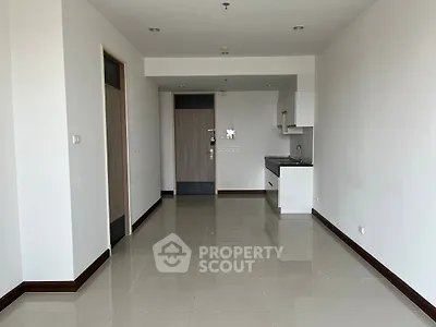 Spacious modern apartment interior with sleek kitchen and glossy tiled floors.