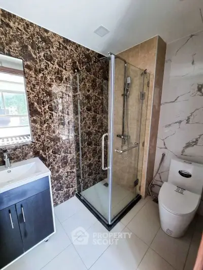 Modern bathroom with glass shower and elegant marble walls