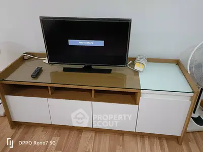 Modern living room setup with sleek TV stand and flat-screen TV, perfect for contemporary homes.
