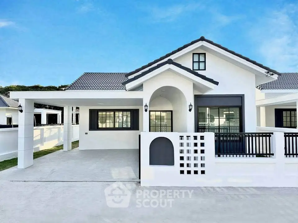 Charming modern white house with spacious driveway and elegant architectural design.