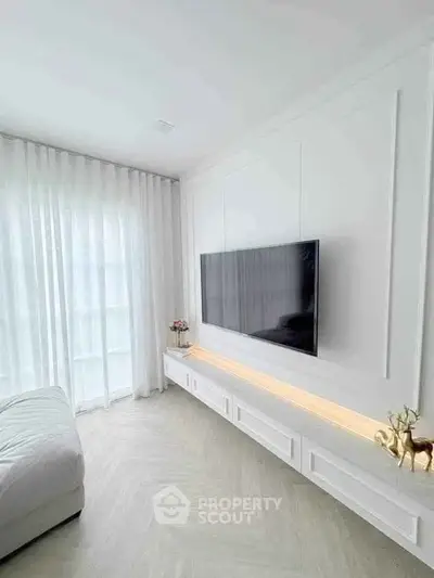 Modern living room with sleek TV setup and elegant white decor