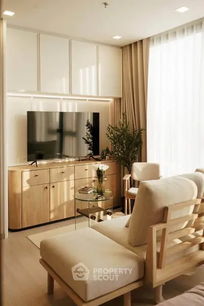 Modern living room with natural light, wooden furniture, and a sleek TV setup.