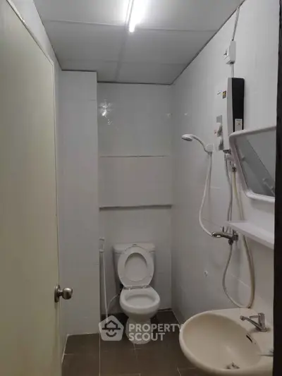 Compact bathroom with modern fixtures and white tiles