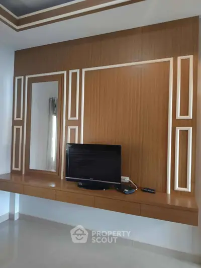 Modern living room with stylish wooden TV wall unit and sleek design.