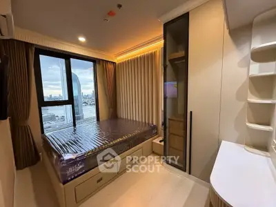 Modern bedroom with city view, featuring built-in storage and sleek design elements.