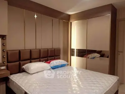 Modern bedroom with stylish padded headboard and mirrored wardrobe