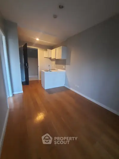 Modern apartment with sleek kitchen and wooden flooring, perfect for urban living.
