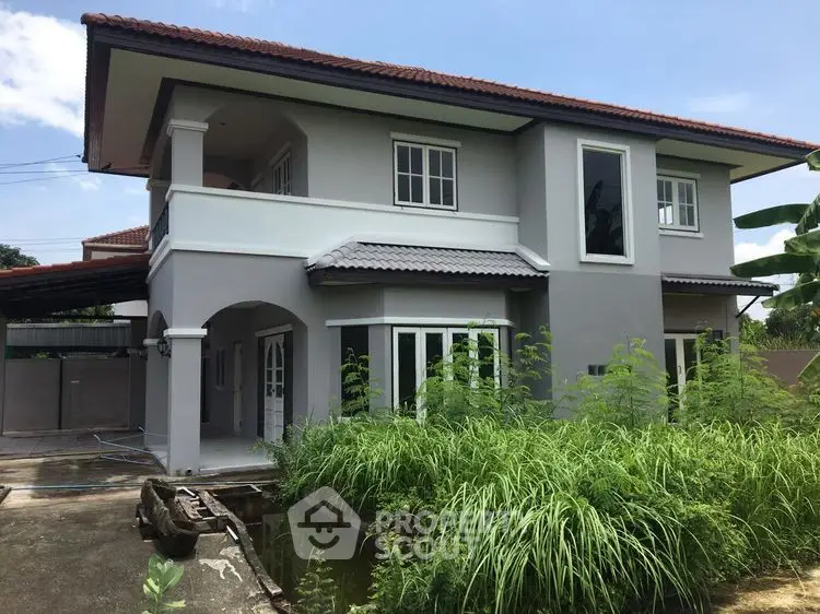 Charming two-story house with lush garden and modern exterior design.