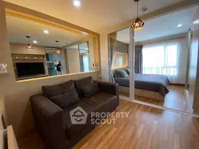 Modern apartment with cozy living room and bedroom separated by glass partition