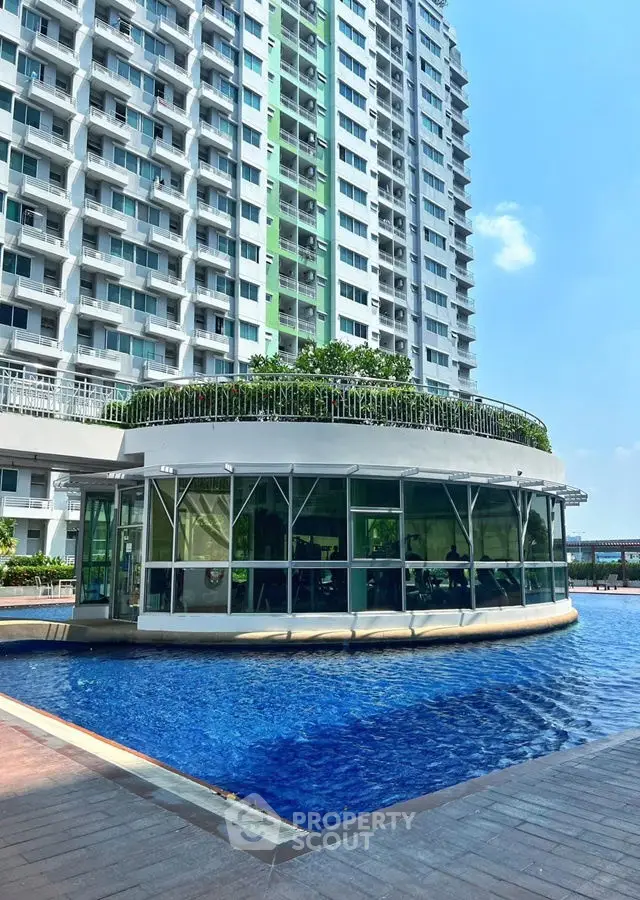 Modern high-rise with pool and lush rooftop garden in urban setting.