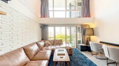 Spacious modern living room with large windows and stylish furniture
