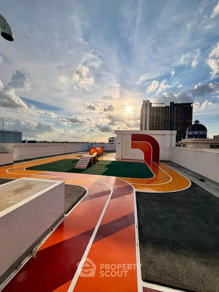 Stunning rooftop with vibrant track and panoramic city views under a bright sky.