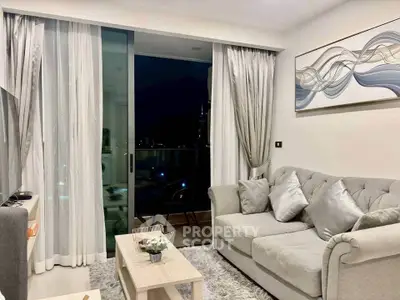 Elegant living room with plush sofa and modern decor, featuring a night view balcony.