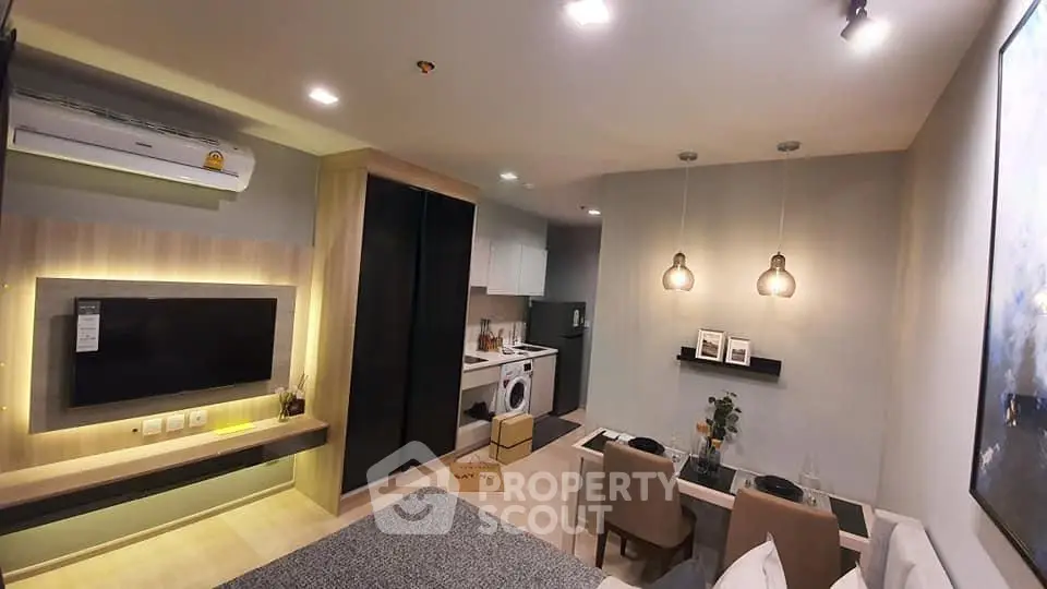 Modern living room with open kitchen, stylish decor, and cozy dining area in a contemporary apartment.