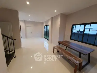 Spacious modern living room with sleek design and large windows