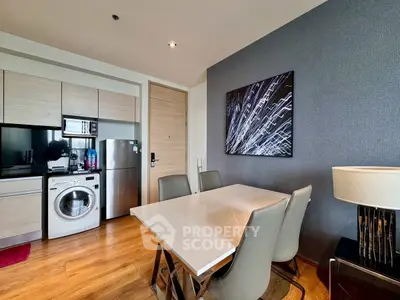 Modern kitchen with dining area featuring sleek appliances and stylish decor