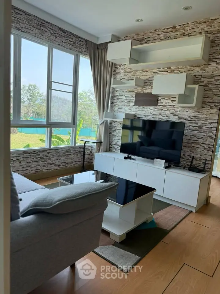 Modern living room with stylish decor and large windows offering scenic views.